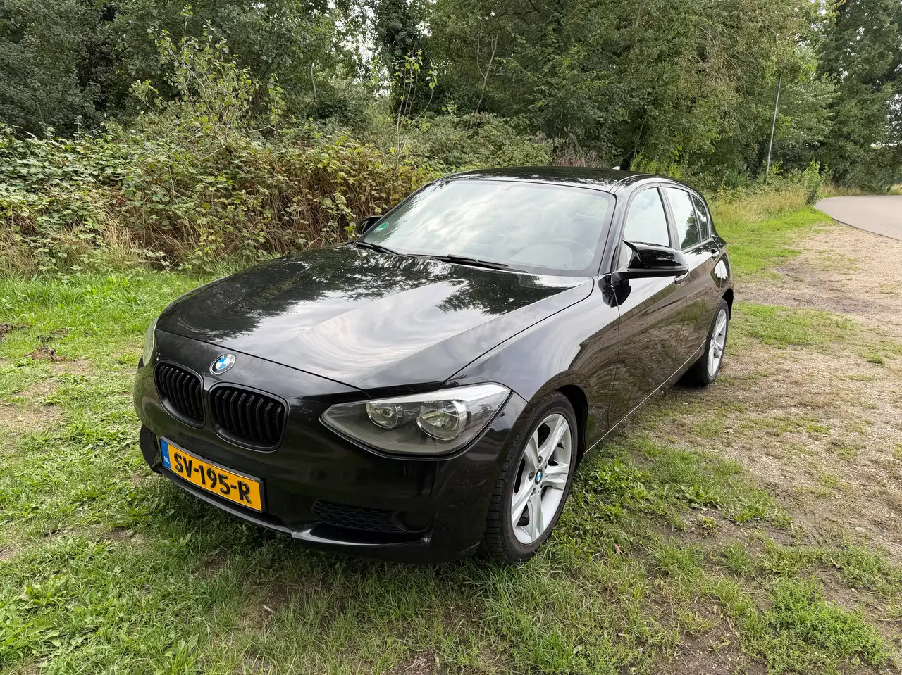 BMW 116 136PK 5DR 2012 Zwart | Airco | PDC — photo 1 of 22